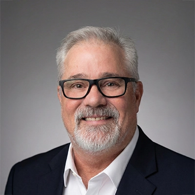 Donovan Hayes smiling in a suit.